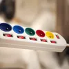 A close-up shot of a white power strip with five colorful outlets and individual switches. Produktbild-Vorschau