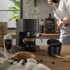 A kitchen scene with an espresso machine, coffee, and a croissant. Produktbild-Vorschau