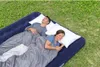 A couple sleeping on an air mattress outdoors on the grass. Náhled obrázku produktu