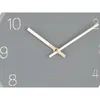 A close-up view of a gray wall clock with gold hands and gold hour markers. Anteprima dell’immagine prodotto