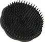 A black scalp massage brush is shown against a white background. Produktbild-Vorschau