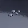 Close-up of water droplets on a dark, reflective surface. Anteprima dell’immagine prodotto