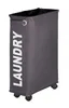 A tall, narrow laundry hamper with wheels. Náhľad obrázku produktu
