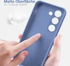 A hand is touching a blue phone case, highlighting its matte surface and soft grip. Produktbild-Vorschau