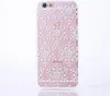 A pink iPhone case with a white snowflake pattern is shown against a white background. Produktbild-Vorschau