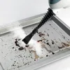 A steam cleaner nozzle is cleaning a dirty baking tray. Náhled obrázku produktu