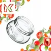 A clear glass jar is shown tilted on a white background, surrounded by various fresh vegetables and herbs. Náhľad obrázku produktu