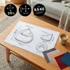 A diagram of a beanbag chair with dimensions and capacity, placed on a wooden coffee table. Voir les images du produit