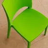 A close-up view of a bright green plastic chair on a tiled floor. Voir les images du produit