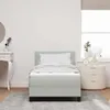 A bedroom scene with a bed, nightstand, and vanity. Produktbild-Vorschau