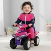 A baby is riding a pink toy quad bike indoors. Náhled obrázku produktu
