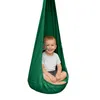 A young child sits in a green hanging chair. Anteprima dell’immagine prodotto