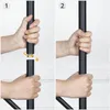 Two images showing hands assembling a black pole, likely part of a coat rack or similar furniture. Náhled obrázku produktu