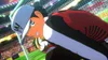 A cartoon character in a soccer uniform, wearing a cap and holding a soccer ball, on a soccer field with spectators in the background. Produktbild-Vorschau