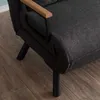 Close-up of the armrest and leg of a dark gray sofa on a wooden floor. Náhled obrázku produktu