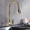 A gold kitchen faucet is shown in a kitchen sink. Náhľad obrázku produktu