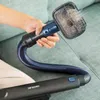 A hand holding a vacuum cleaner attachment with pet hair being removed from a couch. Náhled obrázku produktu