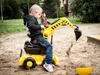 A young boy is playing with a toy excavator in a sandbox. Podgląd zdjęcia produktu