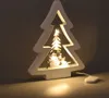 A lit-up wooden Christmas tree decoration with a snowman inside, placed on a surface with a light glow. Produktbild-Vorschau