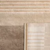 A close-up view of a rug with a striped geometric pattern. Anteprima dell’immagine prodotto