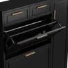 A black shoe cabinet with gold handles, showing an open drawer. Produktbild-Vorschau