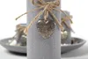 Close-up of a decorative candle with a heart-shaped pendant. Náhled obrázku produktu