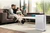 A family is relaxing in a living room with an air purifier. Produktbild-Vorschau