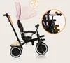 A pink and black tricycle with a canopy and parent handle, shown against a light beige background. A close-up inset shows the handlebars. Produktbild-Vorschau