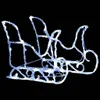 A white and light blue illuminated sleigh decoration against a black background. Podgląd zdjęcia produktu
