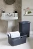 A bathroom scene with a sink, laundry baskets, and towels. Produktbild-Vorschau