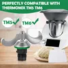 A close-up of a kitchen appliance part, a Thermomix machine, and dough on a wooden surface. Produktbild-Vorschau