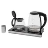 A glass electric kettle and a glass teapot sit on a black induction base, with a metal tea strainer to the left. Podgląd zdjęcia produktu