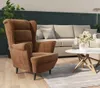 A living room scene with a brown armchair and a beige sofa. Produktbild-Vorschau