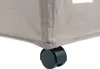Close-up of the bottom corner of a beige laundry basket with a black wheel. Produktbild-Vorschau