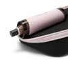 A pink hair dryer brush is placed inside a black carrying case with a pink zipper. Produktbild-Vorschau