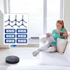 A woman is relaxing on a couch reading a magazine and drinking from a mug, while a robot vacuum cleaner is on the floor in the foreground. A set of replacement parts for the vacuum is displayed in a box in the mid-ground. Voir les images du produit