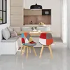 A modern kitchen and dining area with a built-in bench seat and two colorful patchwork chairs at a wooden table. Produktbild-Vorschau