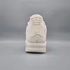 The back view of a cream-colored Nike Air Jordan 4 Retro women's sneaker against a plain gray background. Anteprima dell’immagine prodotto