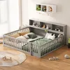 A child's bed with a grey wooden frame and storage shelves, decorated with toys and bedding, in a room with wooden floors and a large window with sheer curtains. Produktbild-Vorschau
