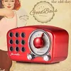 A vintage-style red radio is shown in front of a background featuring a retro illustration of a woman and text. Produktbild-Vorschau
