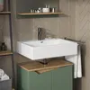 A modern bathroom vanity with a white sink and green cabinet. Voir les images du produit