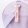 Close-up of a purple backpack with a pink strap and a Pusheen charm. Produktbild-Vorschau