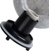 A close-up view of a black plastic cap with a white gasket, attached to a speckled gray object, possibly a lamp base. Náhled obrázku produktu