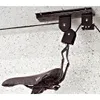 A bicycle ceiling lift system is shown mounted to a ceiling, with a bicycle seat hanging from it. Produktbild-Vorschau