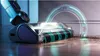 A close-up, dynamic shot of a vacuum cleaner head on a wooden floor, with a futuristic glowing ring in the background. Voir les images du produit