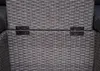 A close-up view of the woven texture of a gray outdoor furniture set, showing two black hinges connecting two sections of the furniture. Produktbild-Vorschau