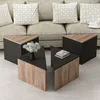 A set of triangular coffee tables in front of a sofa with decorative pillows. Produktbild-Vorschau