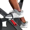 A close-up shot of a person's feet on the pedals of an indoor cycling bike. Voir les images du produit