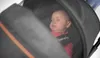 A baby sleeping in a stroller. Anteprima dell’immagine prodotto