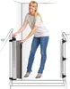 A woman is demonstrating how to use a retractable baby gate at the top of stairs. Náhľad obrázku produktu